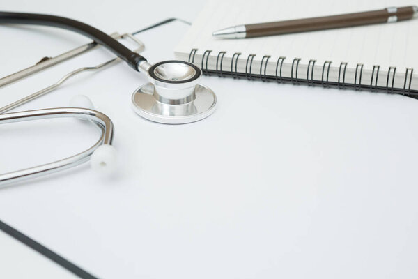 Stethoscope, Document Board, Notebook, Pen on white background and copy space