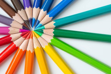 Beyaz arkaplandaki renkli kalemlerin tekerlek deseni ve boşluğu kopyala