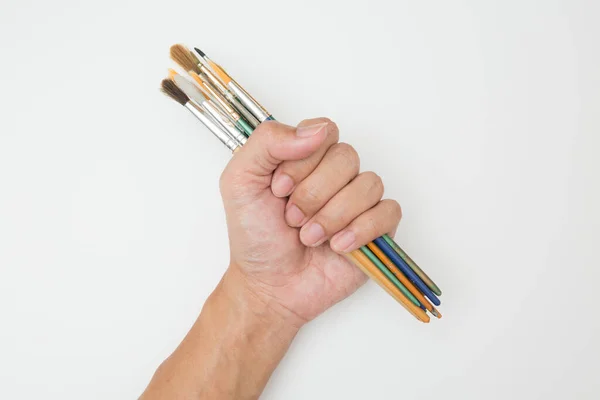 Mão Segurando Muitas Escovas Arte Fundo Branco — Fotografia de Stock