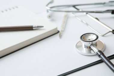Stetoskop, Termometre, Belge Tahtası, Not Defteri, Beyaz arkaplan üzerine Kalem ve Boşluğu Kopyala
