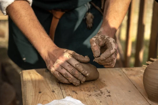 古代の工芸品の復元 陶器を作るために粘土を絞る職人 ワークショップモデルに占領された手 陶芸を教える テーブルの彫刻方法が表示されます 古い衣装に身を包んだ — ストック写真