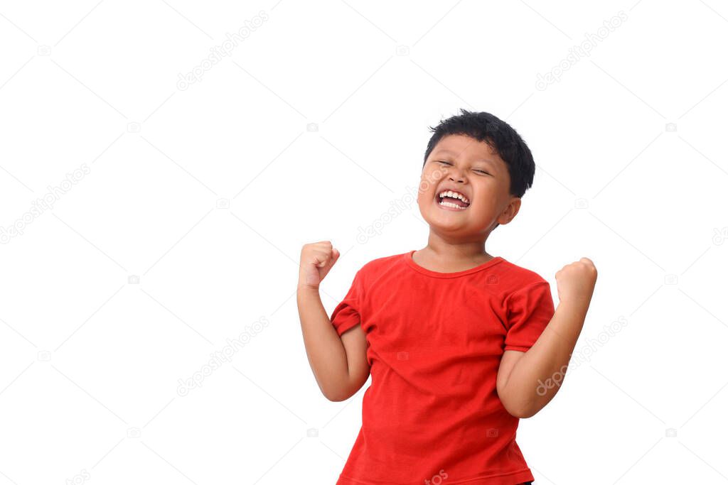 Portrait of delighted asian boy shouting and clenching fists like winner or lucky person isolated over white background