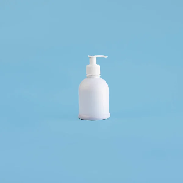 One white plastic mockup dispenser on light blue background. Isolate bottle with pump. Hand sanitizer for virus and infection. Antiseptic drug, Hygiene and Health concept. Square with copy space.