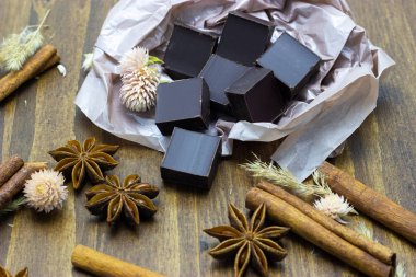 lavanta çiçekleri tarçın ve ahşap bir arka plan üzerinde yıldız anason ile doğal çikolata