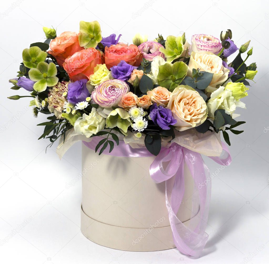 beautiful flower arrangement in a hat box on a white background floral background