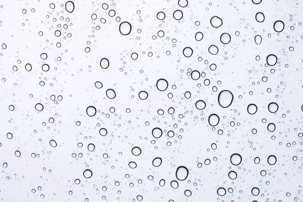 sky view through car window with rain drops.