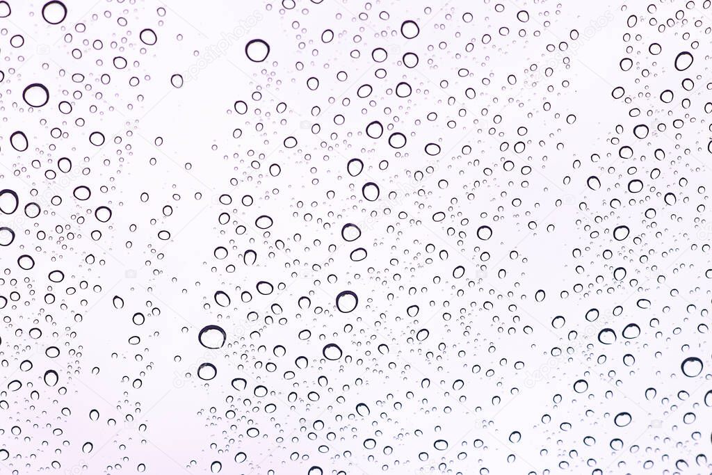 Water droplets adhering to the windshield of the car