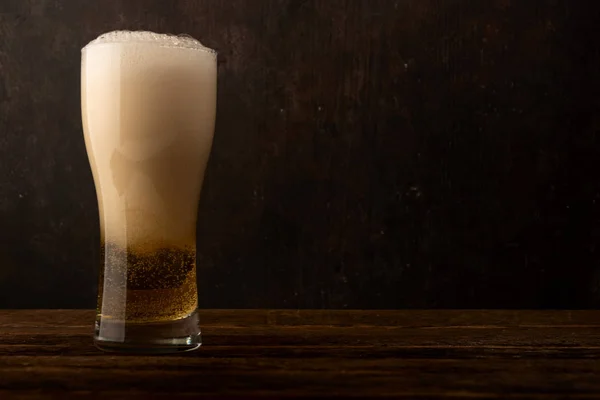 Glass beer on dark wood background with copyspace — Stock Photo, Image