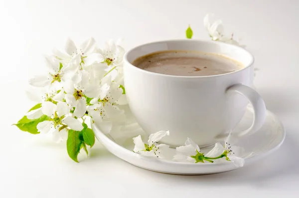 White cup of coffee on a white background, white spring