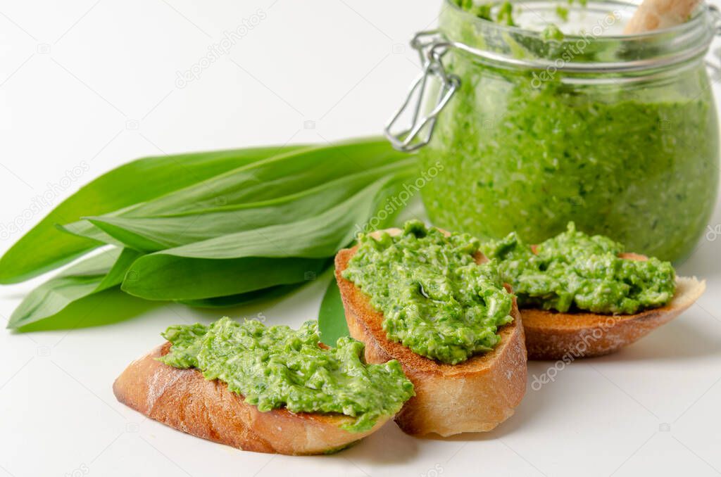 fresh ramson wild garlic pesto on white background with