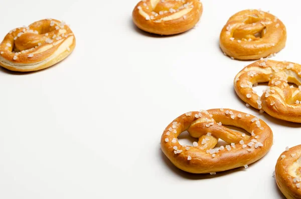 Different tasty homemade pretzels on white background — Stock Photo, Image