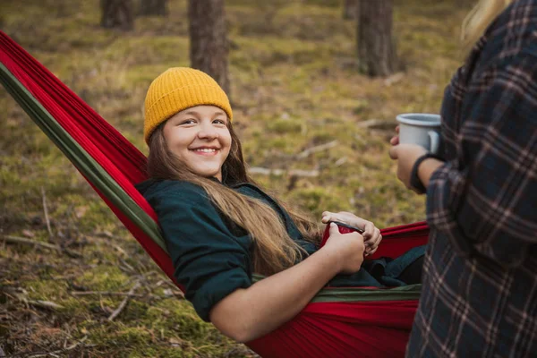 Mutlu genç hipster kız yaz ormanında diğer kadın ile hamak yaşam ve doğa sahiptir.