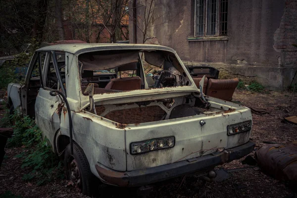 Destroyed and abanoded car in an abandoned place