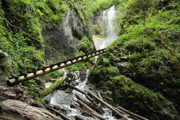 Gefährlicher Weg durch einen Wasserfall mit hölzernen Leitern — Stockfoto