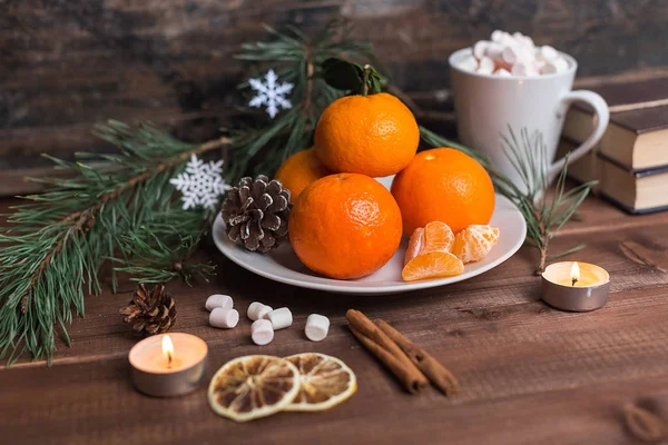 New year's still life with fresh mandarines on a plate with marshmallow and cinnamon — Stock Photo, Image