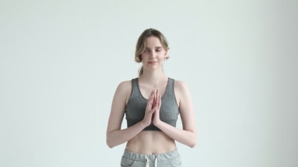 Smiling girl in sportswear, holding hands in namaste gesture. health lifestyle — Stock Video