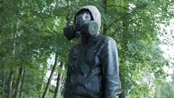 Homme en masque à gaz dans le capot à la forêt. protection des armes chimiques, épidémie de virus — Video