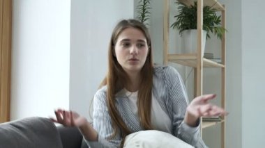 Mutlu kadın blogcu kanepeye oturur ve webcam ile konuşur. video konferans çağrısı