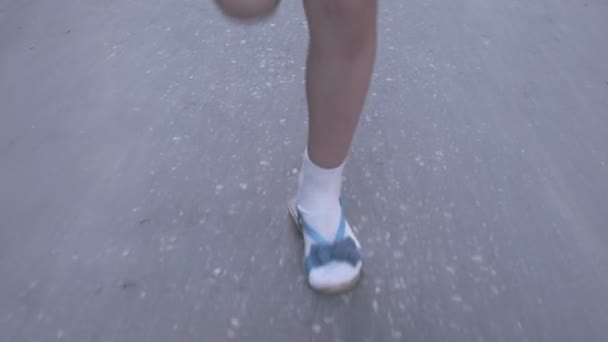 Closeup shot of little girls legs while she jumps playing hopscotch outdoors — Stock Video