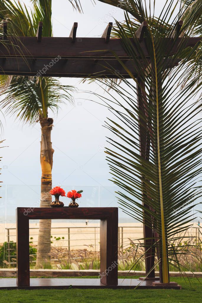 sea water and beach wedding arch construction with table and decoration