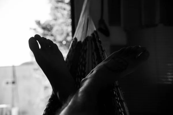 male feet in hammock, black and white