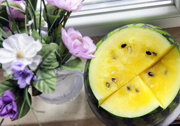 Yellow watermelon, yellow watermelon flesh. Top view of sliced watermelon, on the windowsill