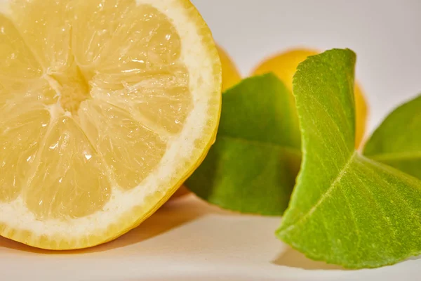 lemons cut with lemon leaves