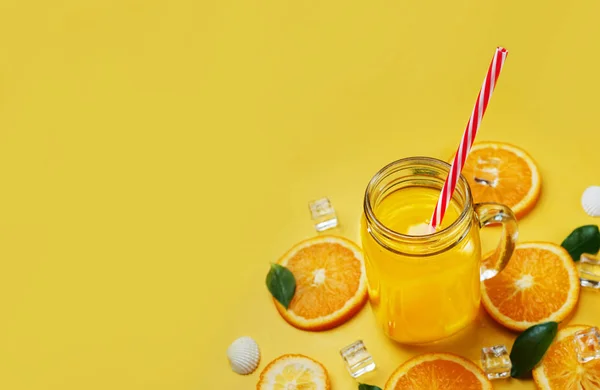 Glass of Orange Juice Leaves Citrus Ice Sea Shells Citrus on Yellow Background Copy Space