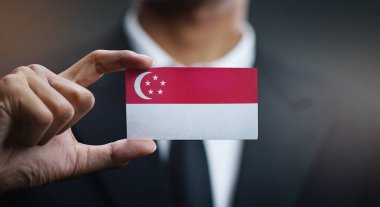 Singapur bayrağı kartı tutan işadamı