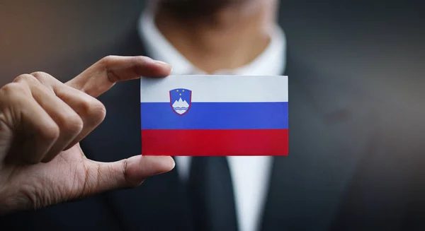Businessman Holding Card of Slovenia Flag