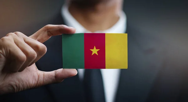 Businessman Holding Card Cameroon Flag — Stock Photo, Image