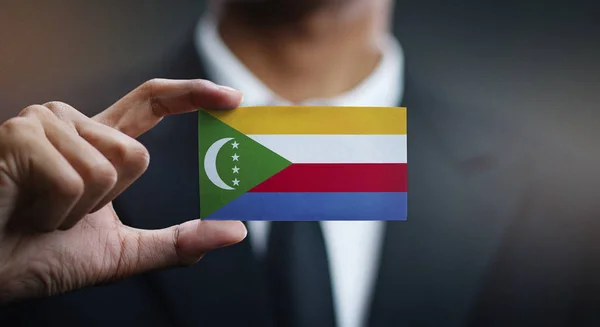Businessman Holding Card Comoros Flag — Stock Photo, Image