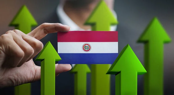 Nation Growth Concept Green Arrows Businessman Holding Card Paraguay Flag — Stock Photo, Image