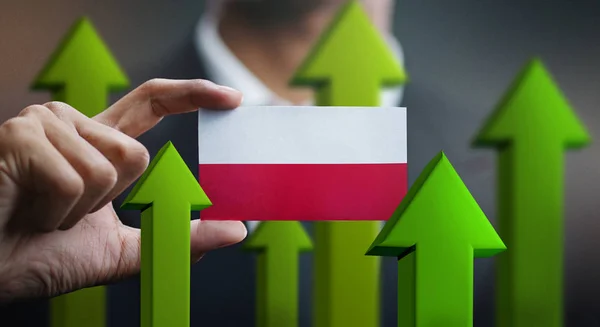 Nation Growth Concept, Green Up Arrows - Businessman Holding Card Poland Flag