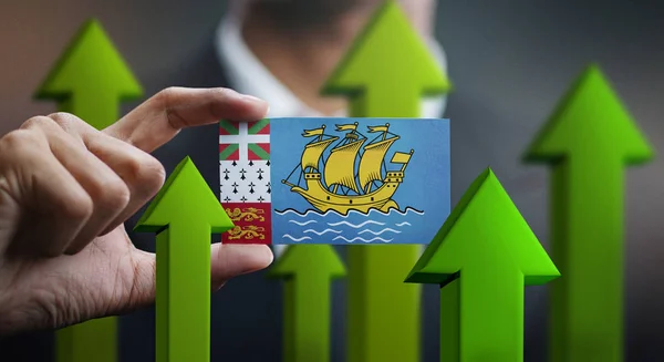 Nation Growth Concept, Green Up Arrows - Businessman Holding Card of Saint Pierre and Miquelon Flag
