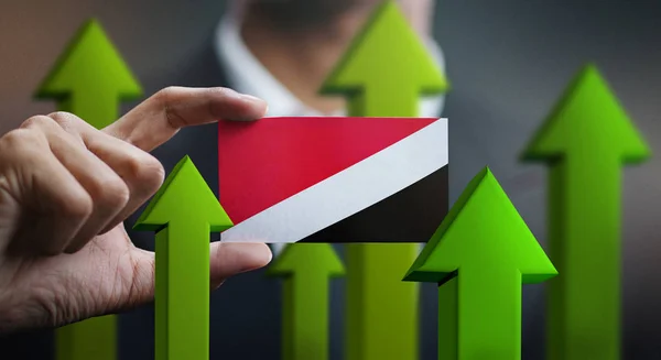 Nation Growth Concept, Green Up Arrows - Businessman Holding Card of Principality of Sealand Flag