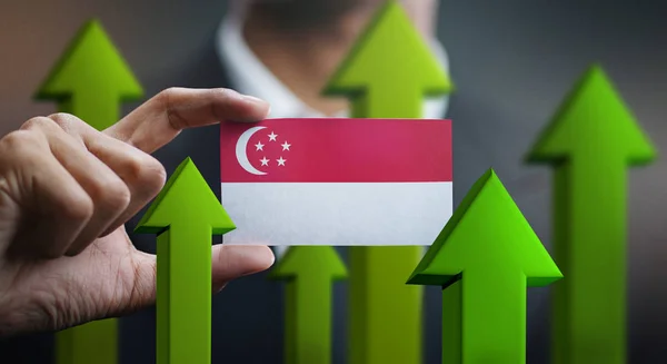 Nation Growth Concept Green Arrows Businessman Holding Card Singapore Flag — Stock Photo, Image