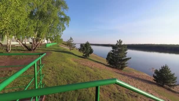 Escaleras a la orilla del atardecer sobre el río — Vídeos de Stock