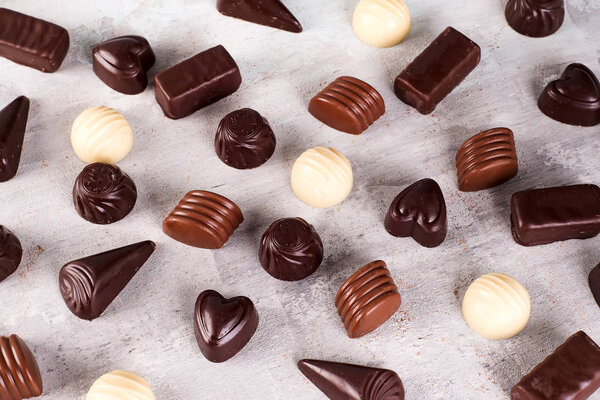 Collection pattern of photos assortment of chocolate candies isolated on stone Sweets background Copy space Top view