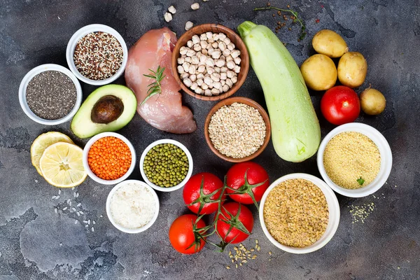 Organic Healthy food Clean eating selection Including Certain Protein Prevents Cancer: meat, spice, vegetable, cereal on a dark stone backgound , flat lay
