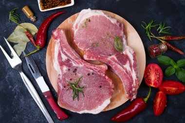 Çiğ et taze sebzeler, otlar ve baharatlar, kemikte kopya alanı, üstten görünüm ile yemek pişirmek için siyah arka plan.