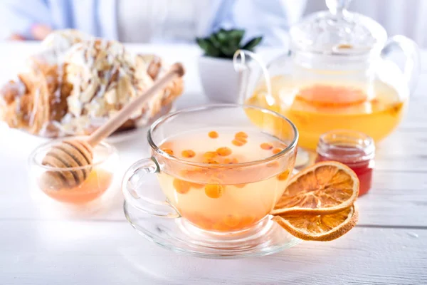 蜂蜜和干橙片的玻璃茶壶中的沙棘茶 — 图库照片