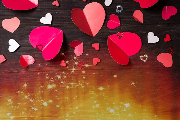 Flying red paper hearts on wooden background. Valentines Day. Symbol of love. — Stock fotografie