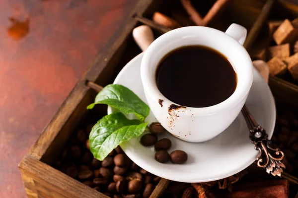 Tasting cup of coffee on the wooden box with spice and different coffee roasted beans on stone background, flat lay — Stock Photo, Image