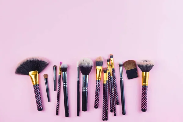 Set of makeup brushes on pink pastel background. Top view point, flat lay. — Stock Photo, Image