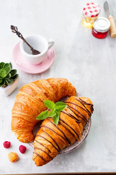 Breakfast on white wooden background - croissant, jam, berries and coffee, flat lay — Stock Photo, Image