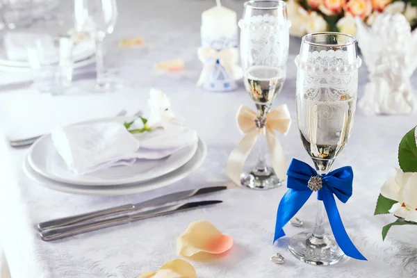 Biancheria da letto bicchieri di champagne sulla tovaglia bianca con tavola apparecchiata su bianco, primo piano — Foto Stock