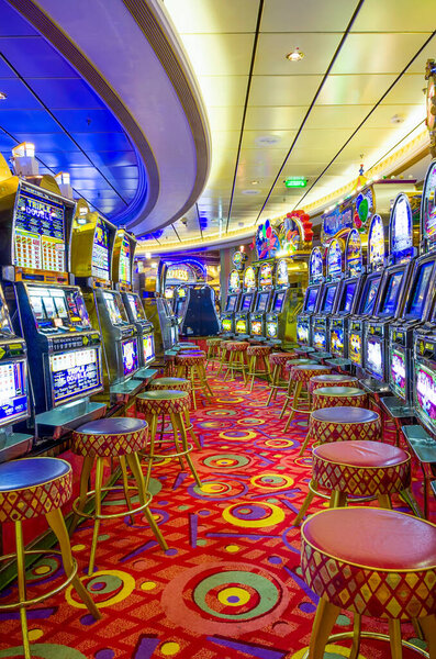 Ship's casino including rows of slot machines