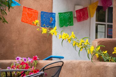 Colorful flowers and decorative napkins seen on Canyon Road in Santa Fe, NM clipart