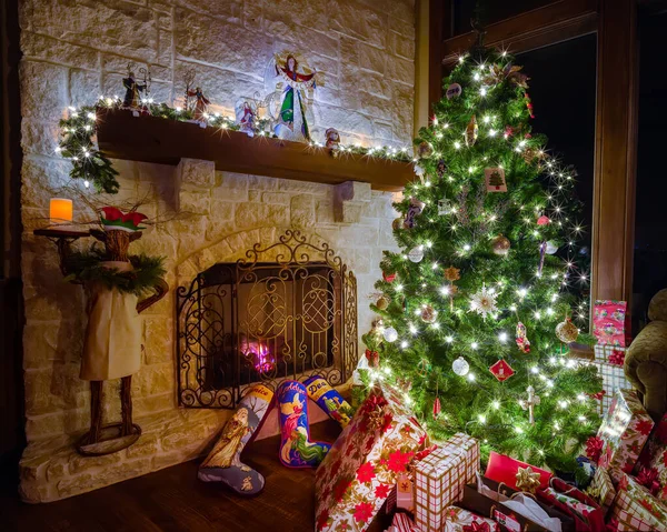 Cozy Christmas scene featuring a fireplace, gifts, and a decorated tree
